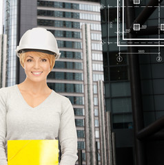 female contractor in white helmet with files