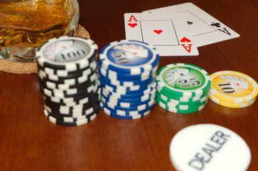 A Pair of Aces and Casino Tokens with a Dealer Button