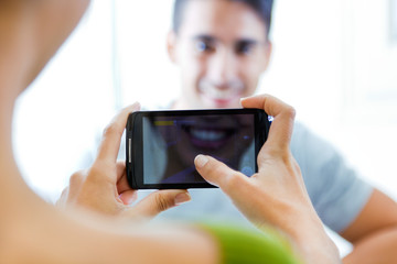 Young couple taking photos with mobile