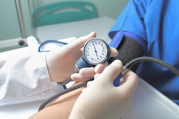 Admission to the hospital. The doctor measures blood pressure