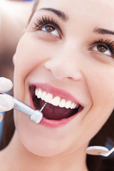 Woman having teeth examined at dentists