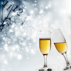 Champagne glasses and clock at midnight
