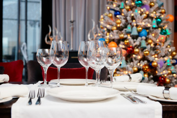 Place setting with Christmas tree in background