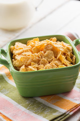 Cornflakes in bowl on table
