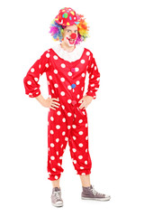 Fototapeta premium Full length portrait of a smiling happy clown in red costume
