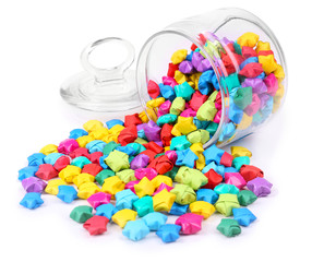 Paper stars with dreams in jar isolated on white