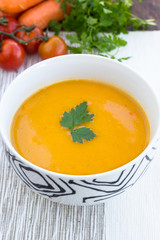 Close up of a bowl of carrot, pumkin and sweet potato soup