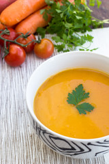 Close up of a bowl of carrot, pumkin and sweet potato soup