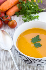 Close up of a bowl of carrot, pumkin and sweet potato soup