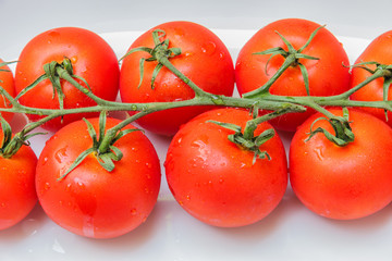Cherry tomatoes in a dish on a table made ​​of wood.