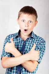 Portrait of a teenage boy showing thumbs up