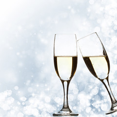Glasses with champagne against holiday lights