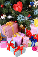 Decorated Christmas tree with gifts, close up,  isolated