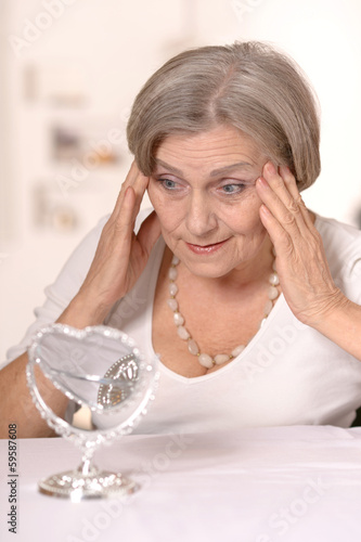 "Senior woman doing makeup" Stock photo and royalty-free images on
