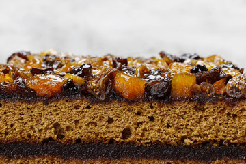 Layer cake decorated with dried fruits and honey. Wooden backgro
