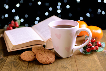 Composition of book with cup of coffee and Christmas