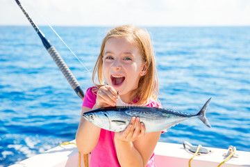 Blond kid girl fishing tuna little tunny happy with catch © lunamarina