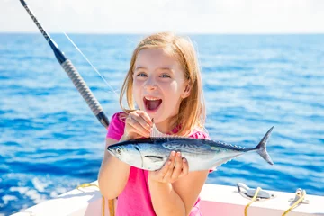 Poster Blond kid girl fishing tuna little tunny happy with catch © lunamarina