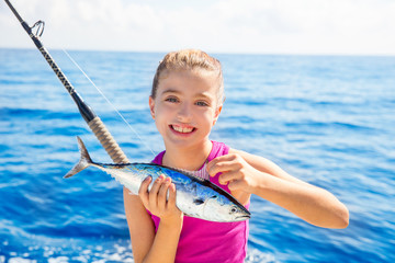 Kid girl fishing tuna little tunny happy with fish catch © lunamarina