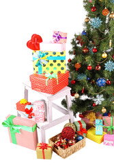 Decorated Christmas tree with gifts isolated on white