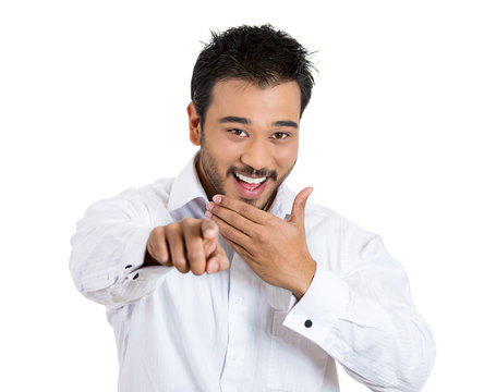 Young man, laughing, pointing  finger at someone