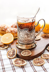 Black tea with lemon in the silver glass-holder