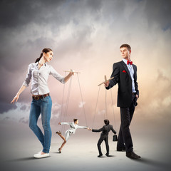 Businesspeople with marionettes