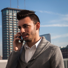 Portrait of a handsome young man talking on phone