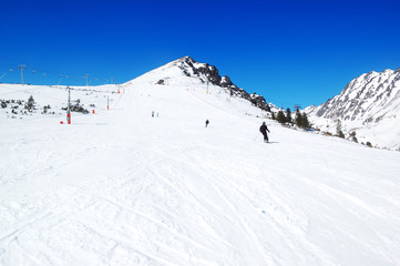 Skiers riding on a slope in Strbske Pleso ski resort, High Tatra