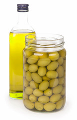 Green olives preserved in bank and a bottle of olive oil