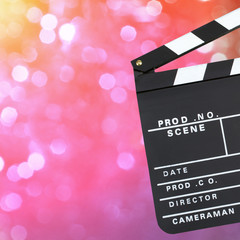 Movie production clapper board over romantic background