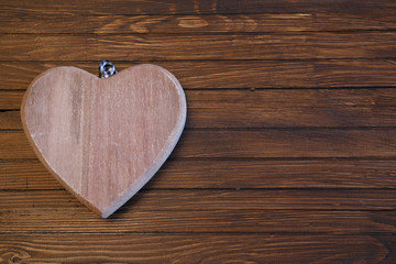 Wooden heart on an old wooden table