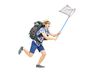 Full length portrait of male tourist running with butterfly net