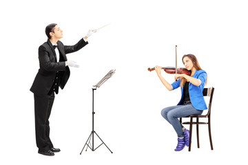 Male orchestra conductor directing a female playing violin