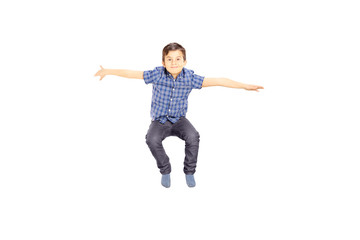 Smiling little boy jumping