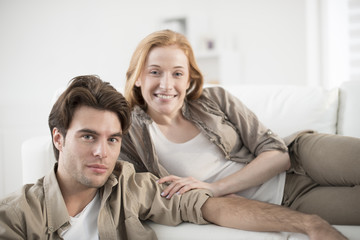closeup of young couple in living room looking at camera