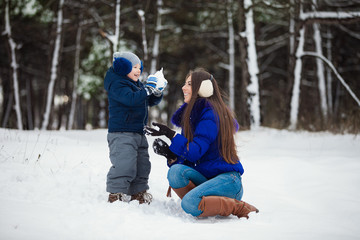 Fototapeta na wymiar Mother and son enjoying beautiful winter day