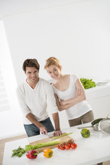 couple in the kitchen cooking vegetables