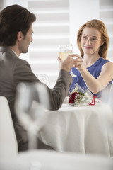 Obraz na płótnie Canvas romantic couple toast with champagne at restaurant