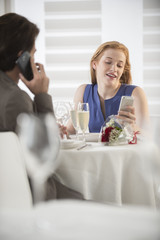romantic couple bored together at restaurant