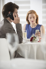 romantic couple bored together at restaurant