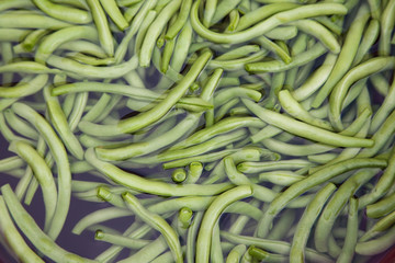 Raw green asparagus beans in water