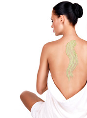 Fototapeta premium woman cares about skin of body using cosmetic scrub on the back