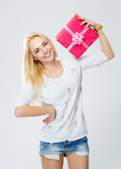 Young, cheerful girl holding a gift, isolated on white backgroun