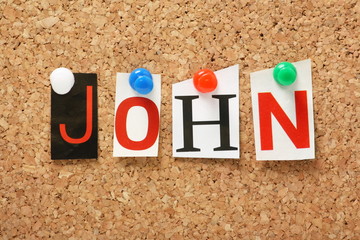 The name John on a cork notice board