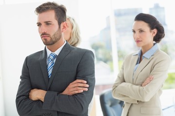 Confident and serious business team with arms crossed