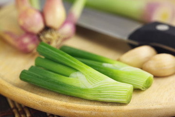 Sliced onion leaves with onion and knife