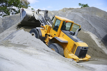 Wheel loader Excavator unloading sand during earth moving works