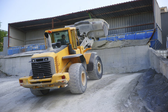 Wheel loader Excavator unloading sand during earth moving works