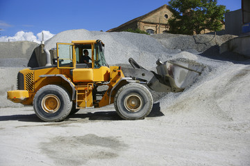 Wheel loader Excavator unloading sand during earth moving works